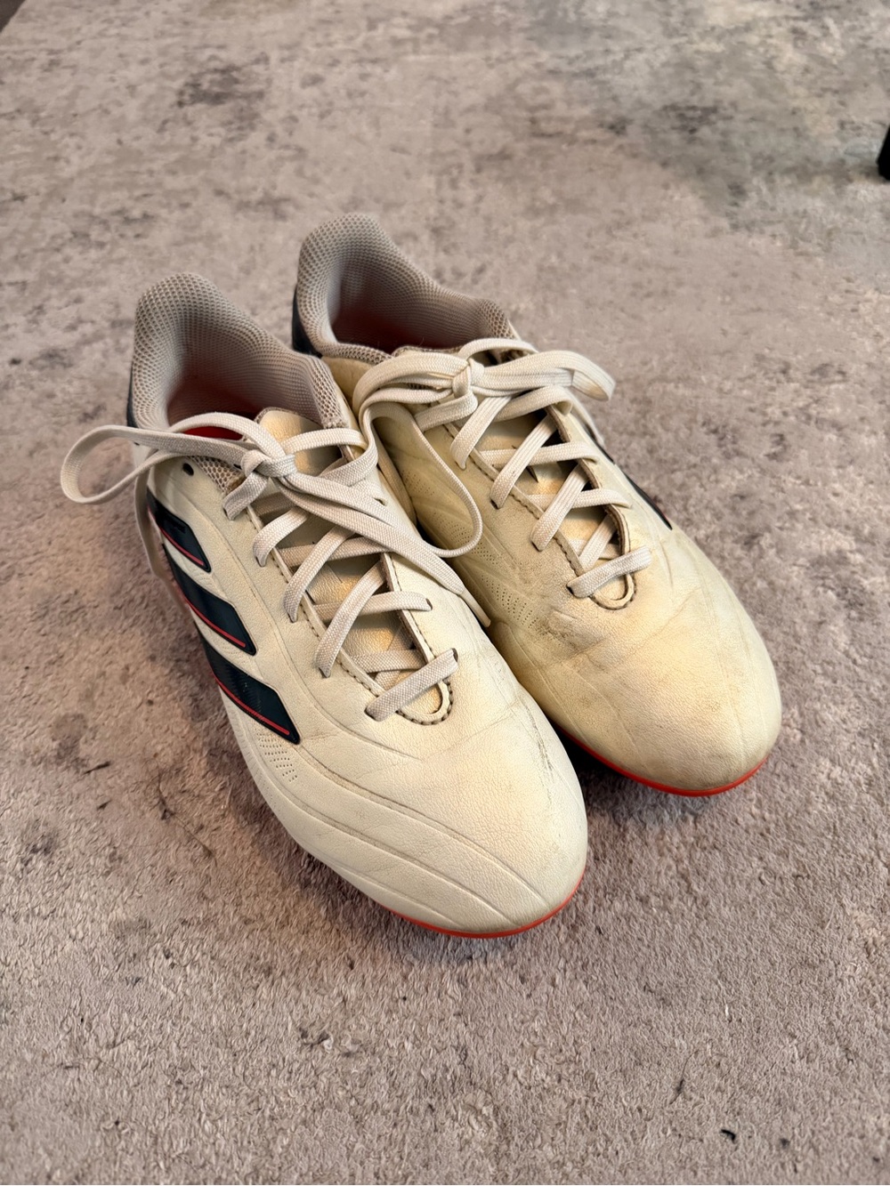 adidas Cream Athletic Shoes with Black Stripes and Red Soles